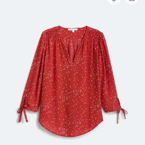 Fun2fun rust colored shirt with a cream colored design size small.